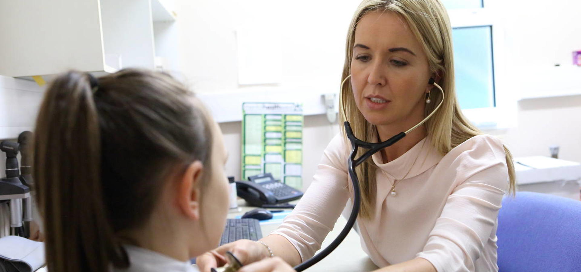 Female GP with child patient 24875