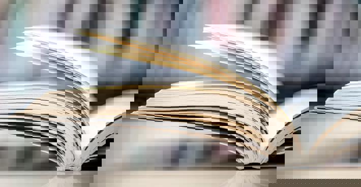 A book lying open on a table out of focus