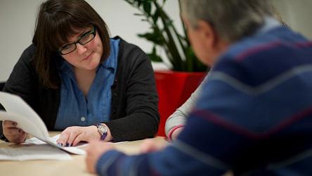 Man And Woman Discussing A Document