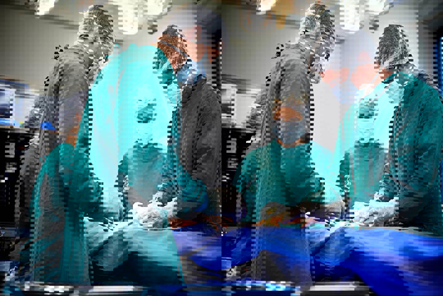Three surgeons operating 19020 8